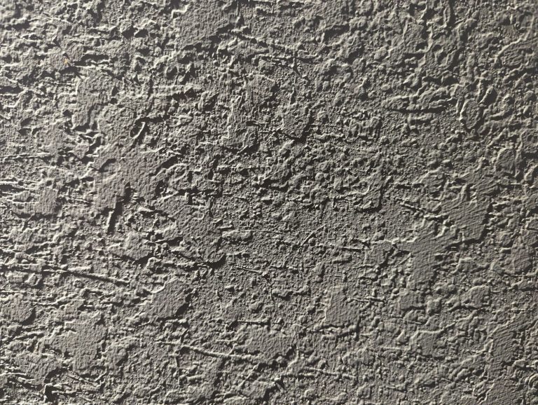 a close up of a cement wall with cracks